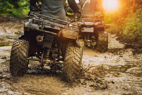 man riding atv vehicle on off road track