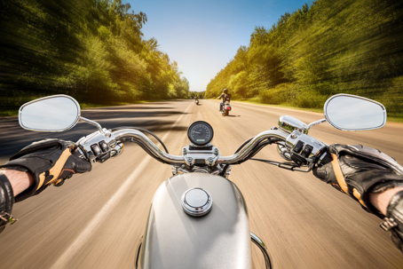 Biker driving a motorcycle rides along the asphalt road. First-person view.