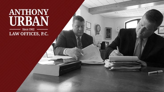 Brian Urban and Anthony Urban reviewing paperwork